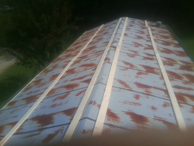 Rusted metal roof panels with new wood purlins before replacement — Storm Damage Roof Repair in Fishs Eddy by Roofing Brothers