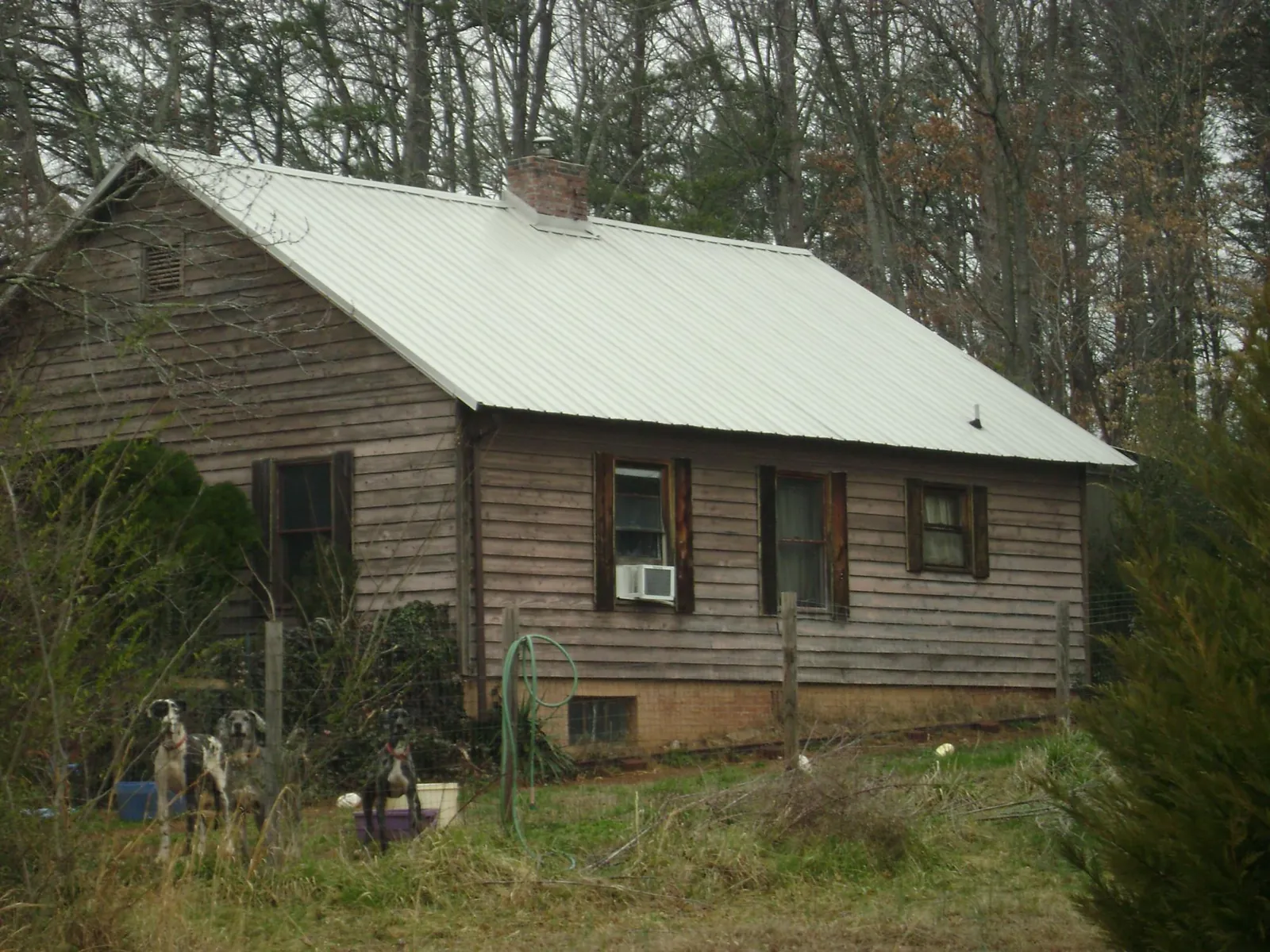 White metal roof on an old wood sided farmhouse, from a Metal Roof Installation job in Fishs Eddy